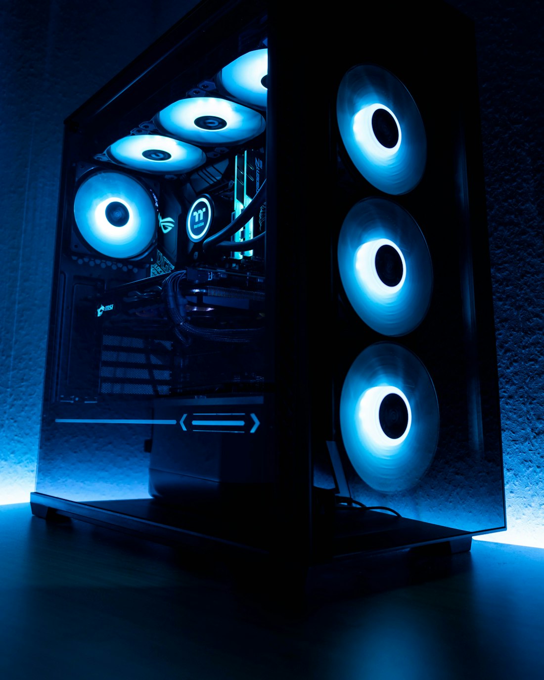 A gaming PC with RGB-lit components on a dark desk